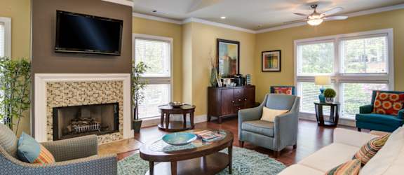 Pet-Friendly Apartments in Marietta– Wood Pointe Apartments – Our Clubhouse with a fireplace and a television.