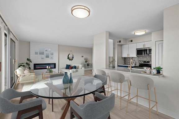 A modern kitchen with a glass table and chairs.