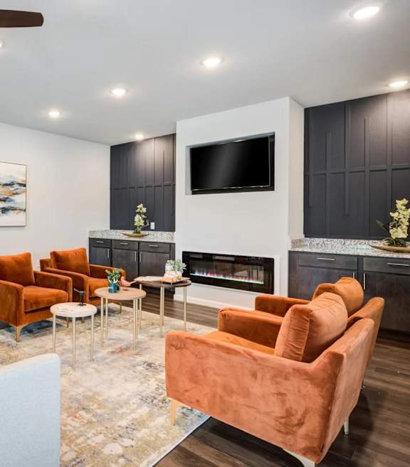 A living room with a fireplace, a television, and a sofa.
