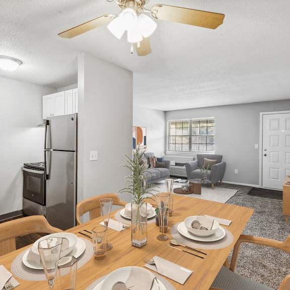 A dining room with a wooden table set for a meal.
