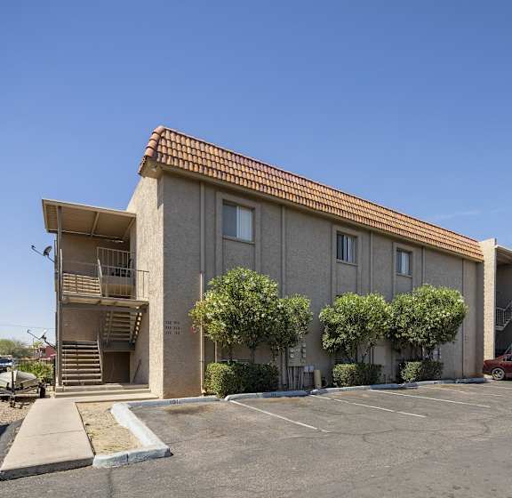 A building with a parking lot in front of it.