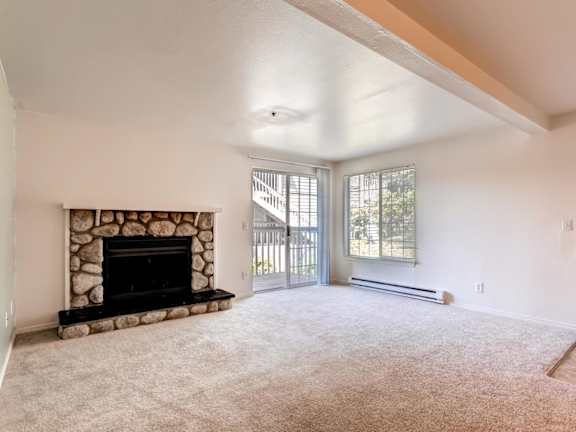 A living room with a fireplace and sliding glass doors.