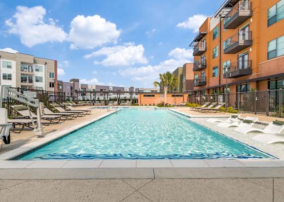 A swimming pool in front of apartment buildings.
