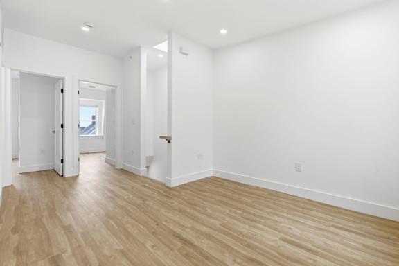 A room with wooden floors and white walls.