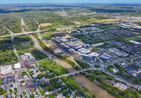 an aerial view of a city with a river and highways