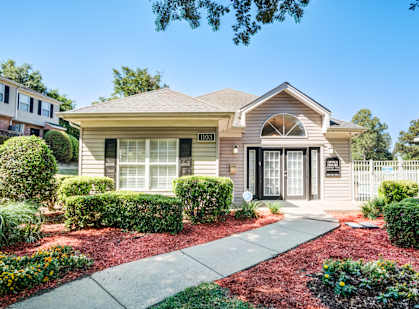 A house with a front yard and a driveway.