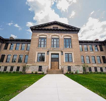 A large building with a long walkway in front.