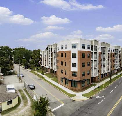 an aerial view of an apartment building on a city street