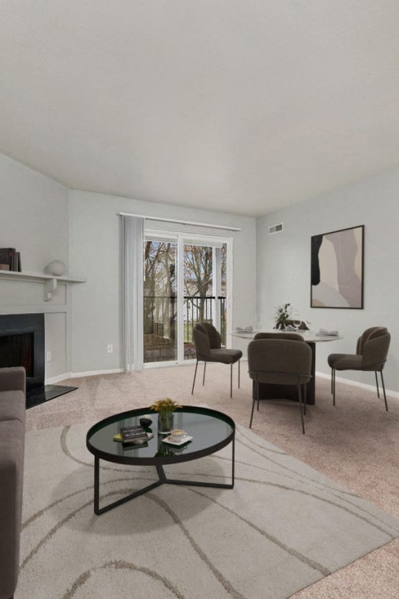 a living room with a couch and a table with chairs