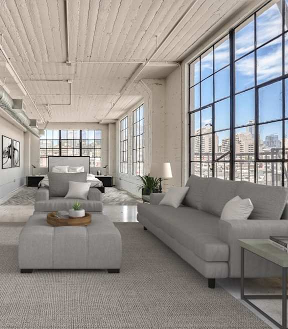A modern living room with a grey sofa and a wooden coffee table.