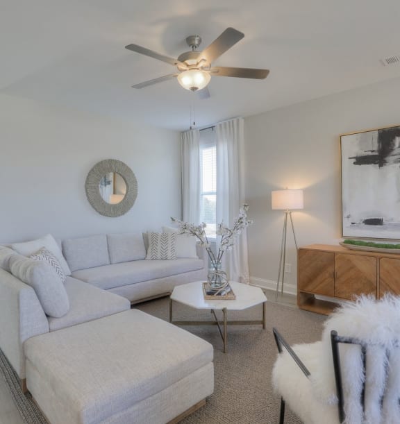 Living room with white sofa and ceiling fan at 1104 Residences homes for rent in Antioch, TN.	