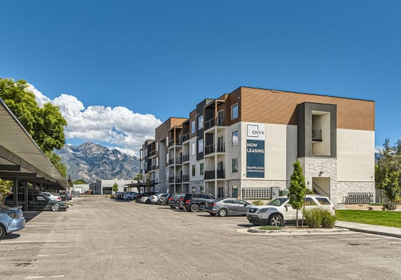 a building with cars parked in front of it on a street
