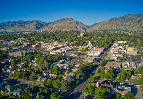 a aerial view of a city with mountains in the background