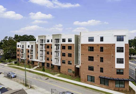 an aerial view of an apartment building on a city street