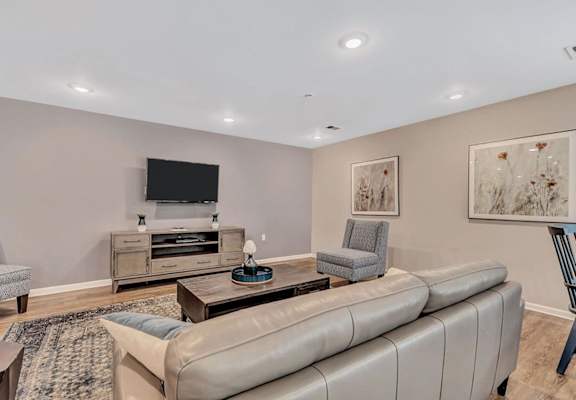 a living room with a couch and two chairs