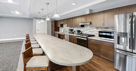 a kitchen with stainless steel appliances and a marble counter top