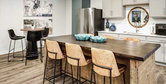 A modern kitchen with dark wood cabinets and stainless steel appliances.