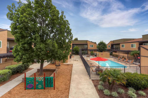 The Community Courtyard, Pool, and Playground at Midway Gardens Apartments