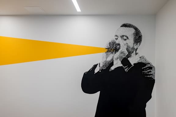 a mural of a man smoking a      on a white wall