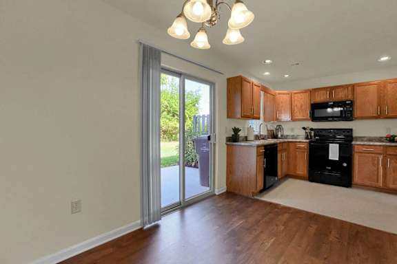 a kitchen with a sliding glass door to a patio