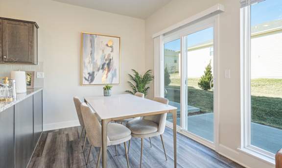 A dining room with a table and chairs.