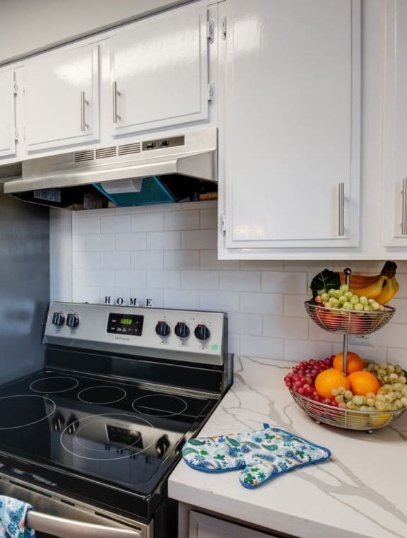 a kitchen with stainless steel appliances and white cabinets