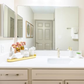 a white bathroom with a sink and a mirror