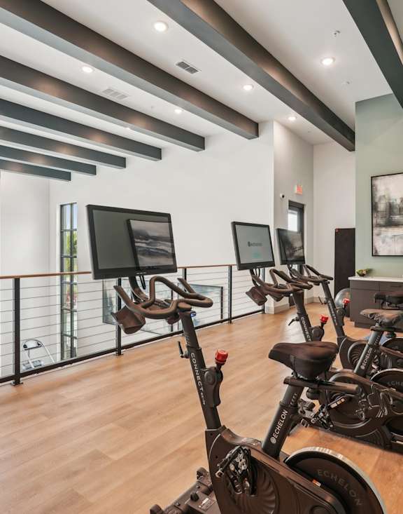A gym with a variety of equipment including a rowing machine.