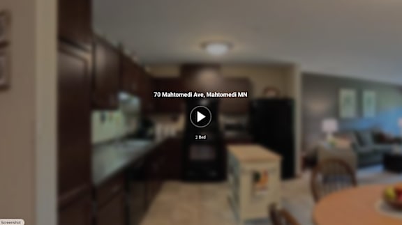 A video player with a play button overlay is on a screen showing a kitchen.