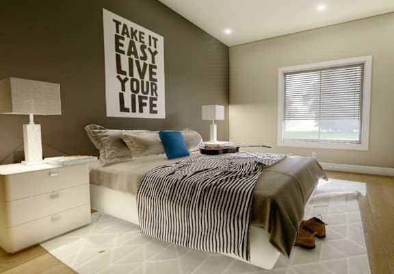 A bedroom with a bed, nightstands, and a lamp.