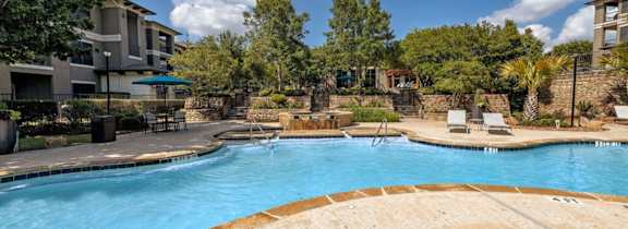 A large house with a pool in front.