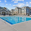 A playground with a blue slide and wooden structure. at Litchford 315 Apartments, Raleigh, NC, 27615