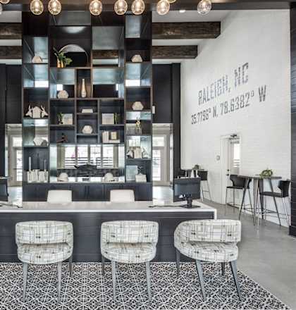 a lobby with a bar and chairs and a living room