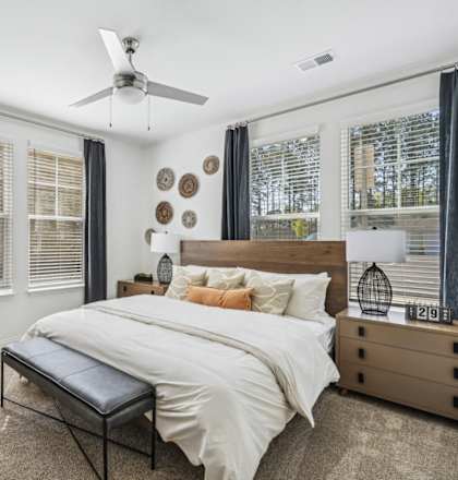 a bedroom with a bed and a ceiling fan