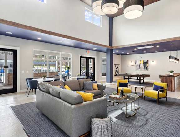 a living room with couches and chairs and a table