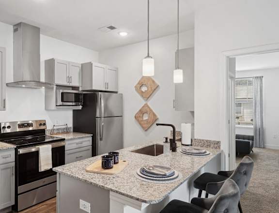 a kitchen with granite counter tops and stainless steel appliances