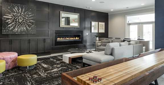 a living room with a couch and a table and a fireplace