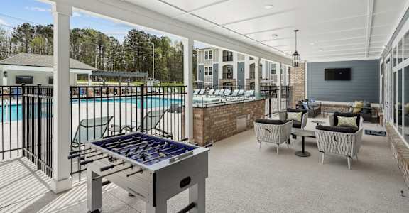 the preserve at ballantyne commons pool and patio area with a foosball