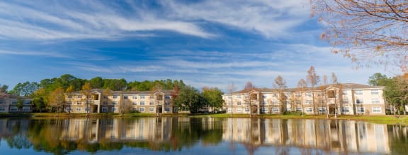 exterior of apartmend buildings behind a large pond