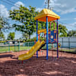 A playground with a blue slide and wooden structure.