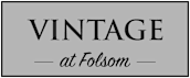 A sign that says "Vintage at Folsom" in black text on a grey background.