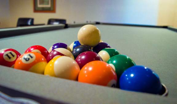 a collection of billiard balls on a pool table