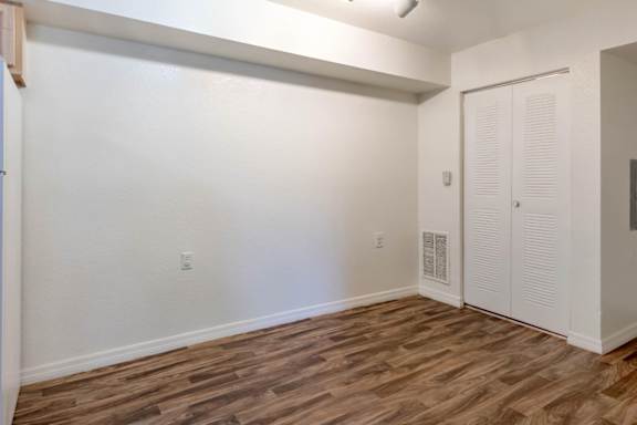 Dining Room with Hardwood Style Flooring with Utility Closet for Washer and Dryer Connection