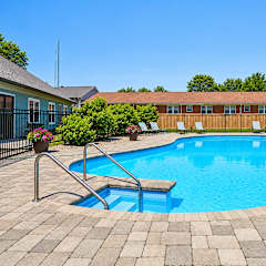 A small pool with a ladder in the middle of it.