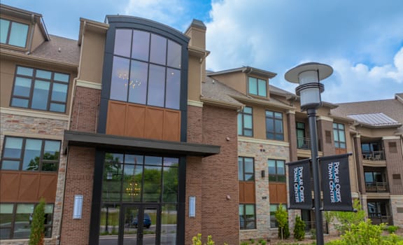 A building with a large glass door and a sign that says "Bow Crafted" on it.