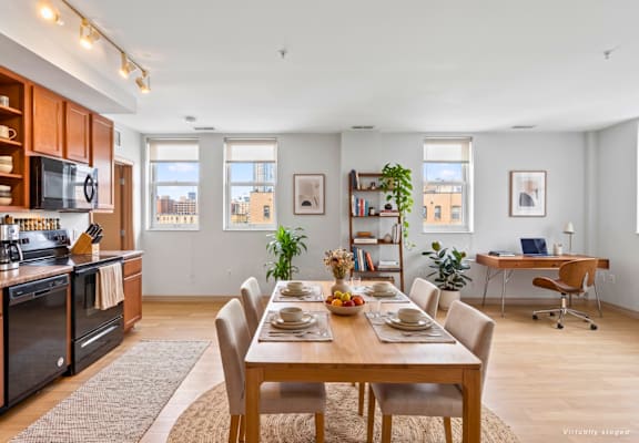 A dining room with a table set for a meal.