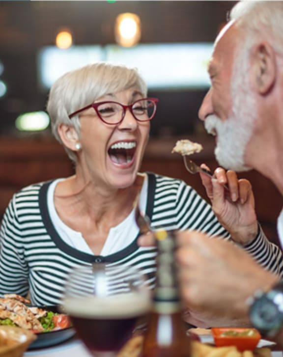 A family of three is having a meal together at an outdoor restaurant.