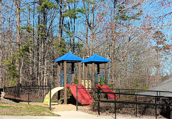 a playground with a swing set and slides