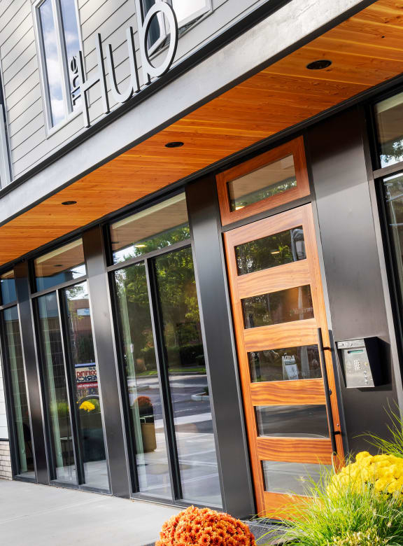 the front entrance of a building with wood and glass doors  at The Hub, Lacey, WA