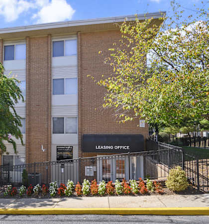 A brick building with a leasing office on the ground floor.